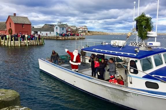 Santa comes to Rockport Ma by lobster boat to kick off the Holiday season in Rockport Massachusetts!
